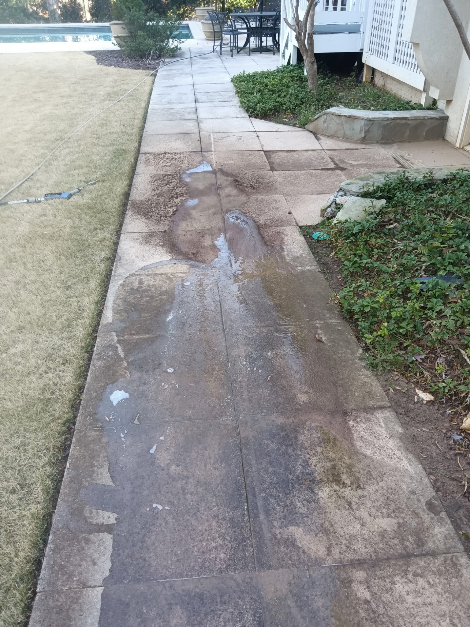 Dirty darkened concrete walkway before pressure washing in Holly Springs GA