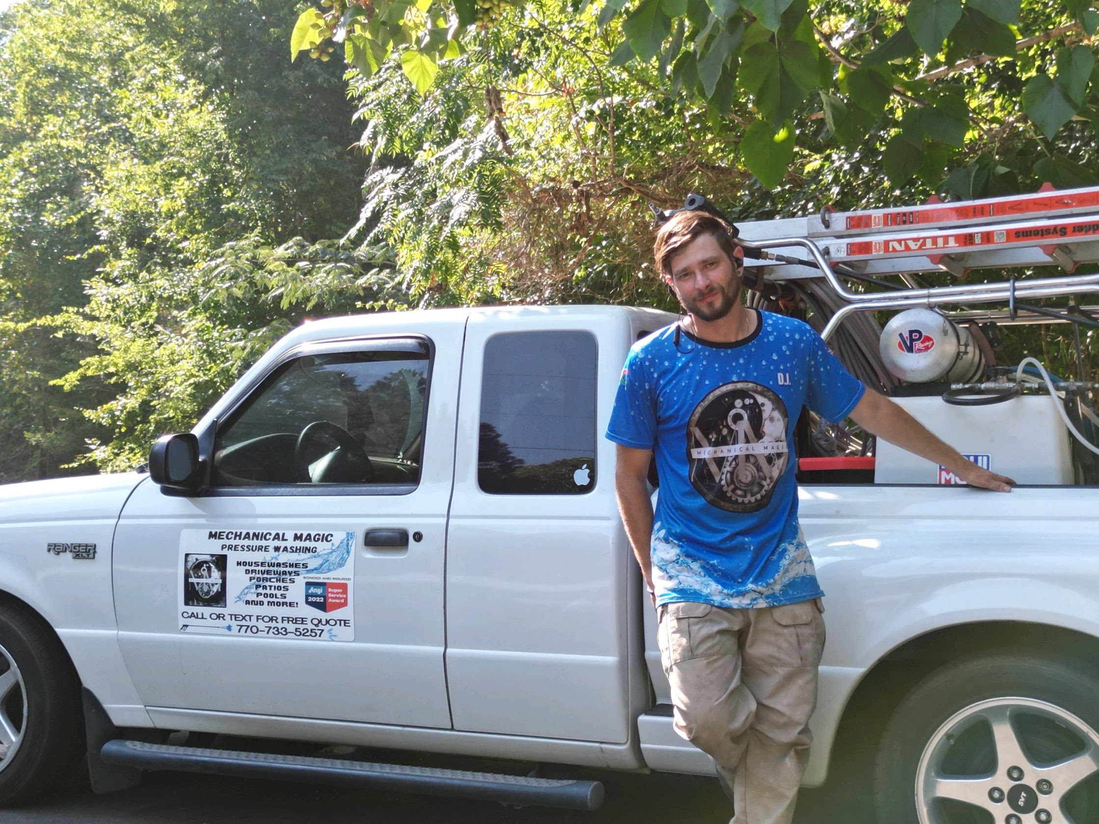 DJ — Owner of Mechanical Magic Pressure Washing — standing next to his work truck in Canton GA