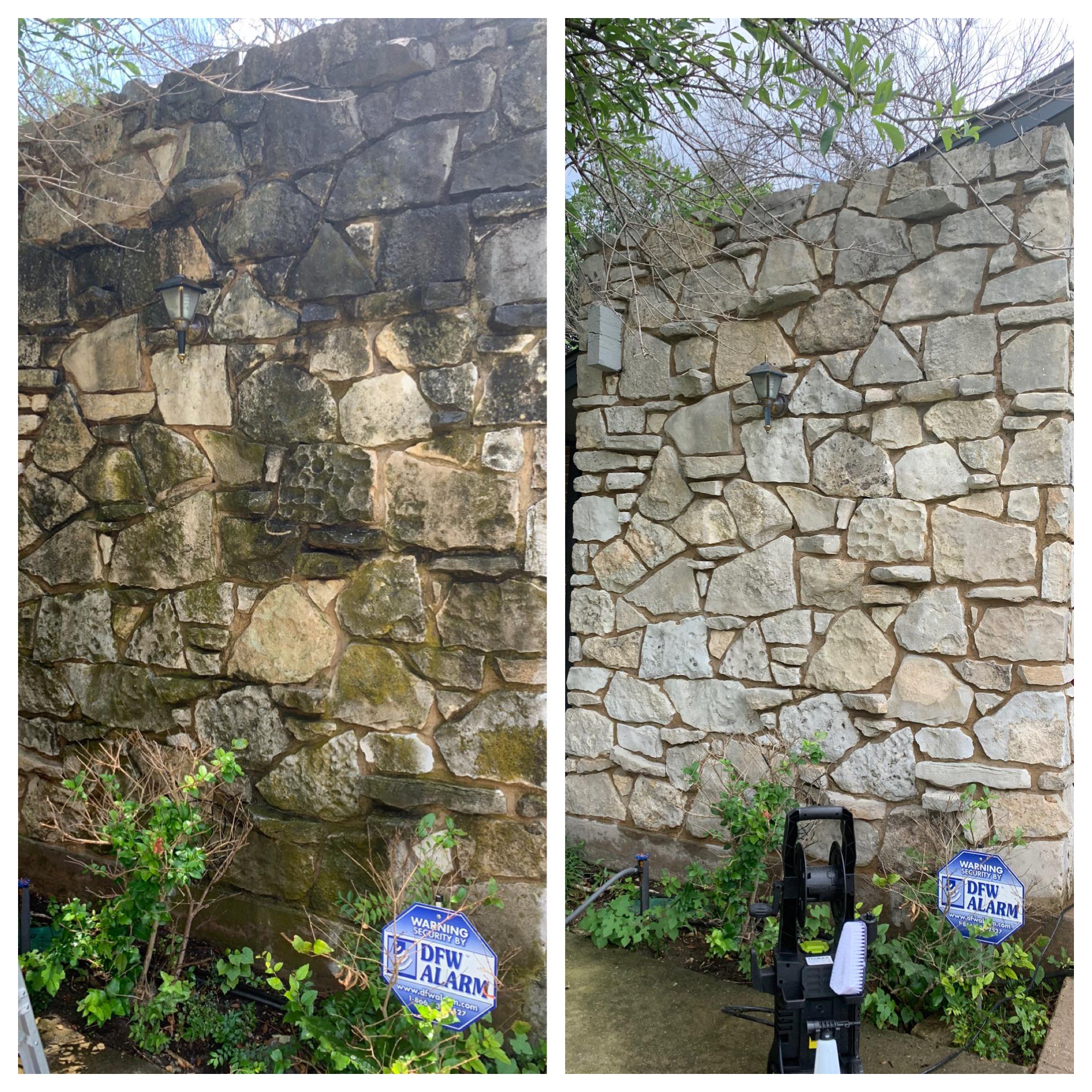 Retaining wall pressure washing showing clean blocks next to dirty section
