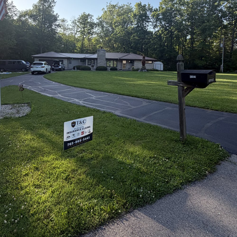 Finished T&C roof with our insurance-claim yard sign out front