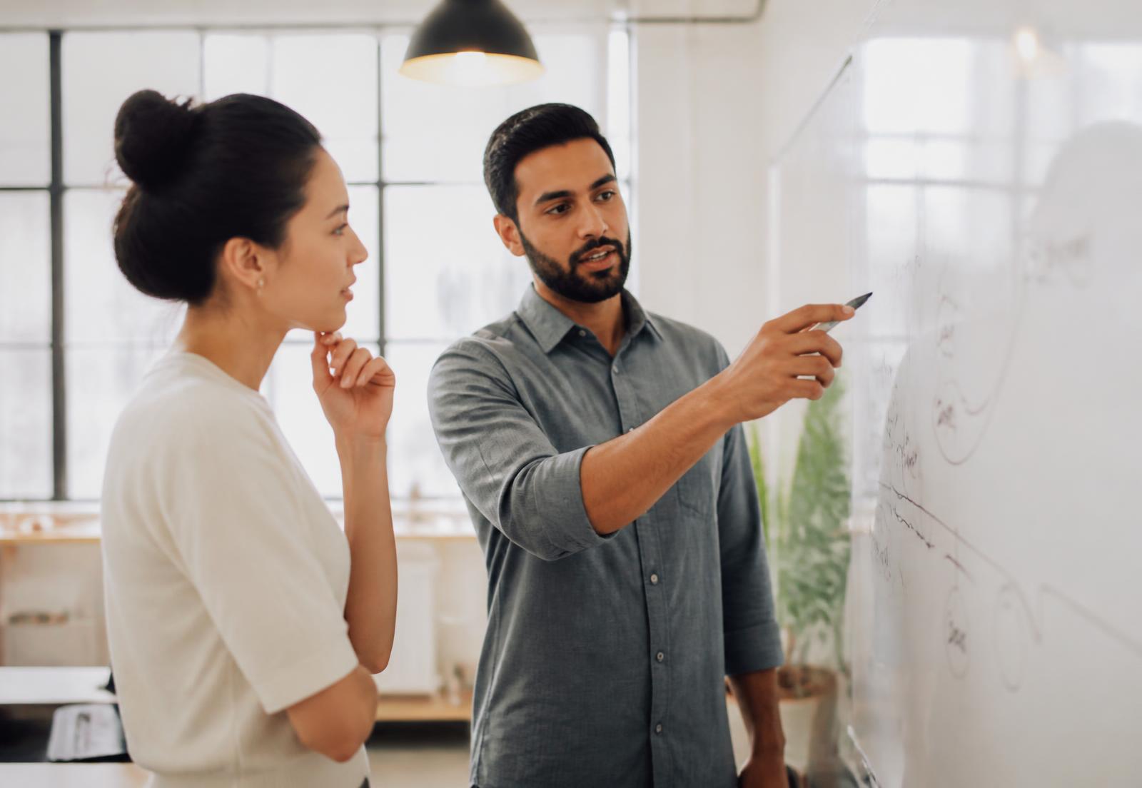 Healthtech founders mapping their go-to-market strategy on a whiteboard