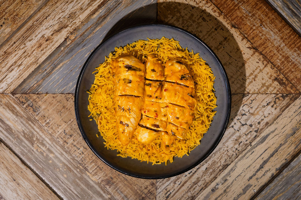 Grilled peri peri chicken over yellow rice