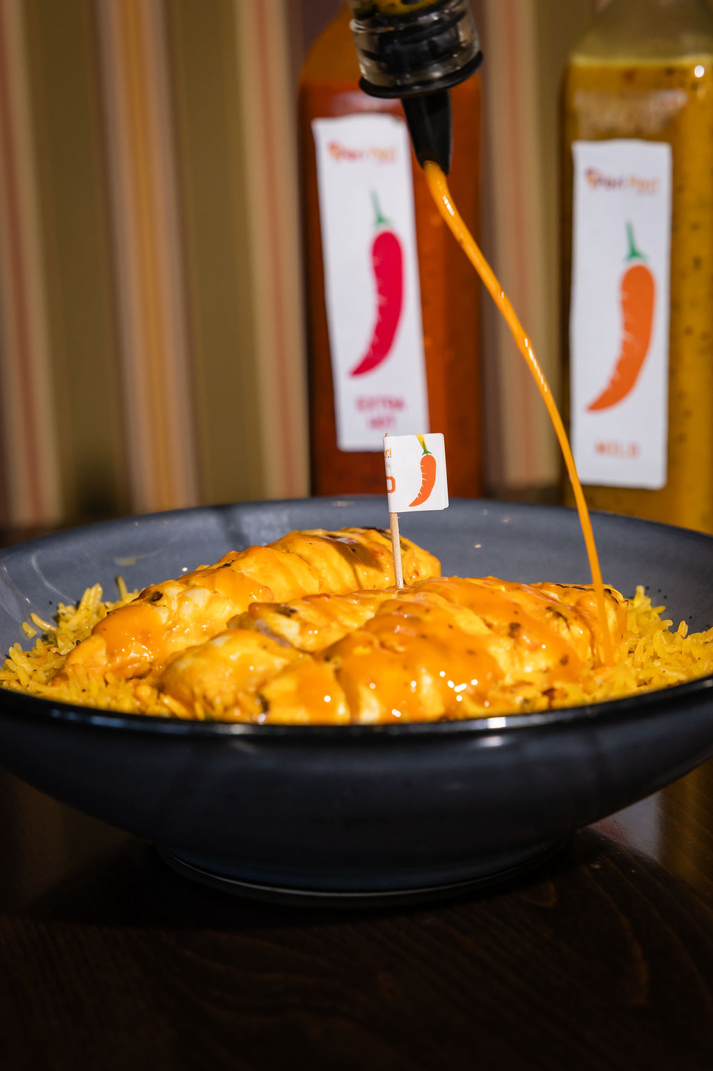 Flame-grilled peri peri half chicken with lemon herb sauce and yellow rice