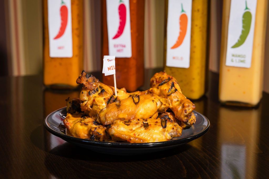 Grilled peri peri chicken breast with orange cream sauce over rice