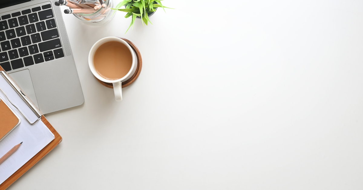 Coffee cup on desk, pink and feminine feel to image