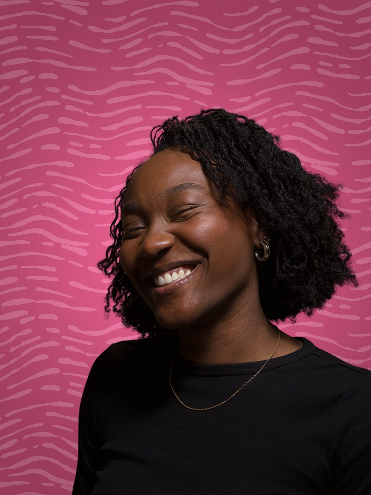 Woman with Shoulder length sisterlocs wearing a lime green blazer in front of a magenta background