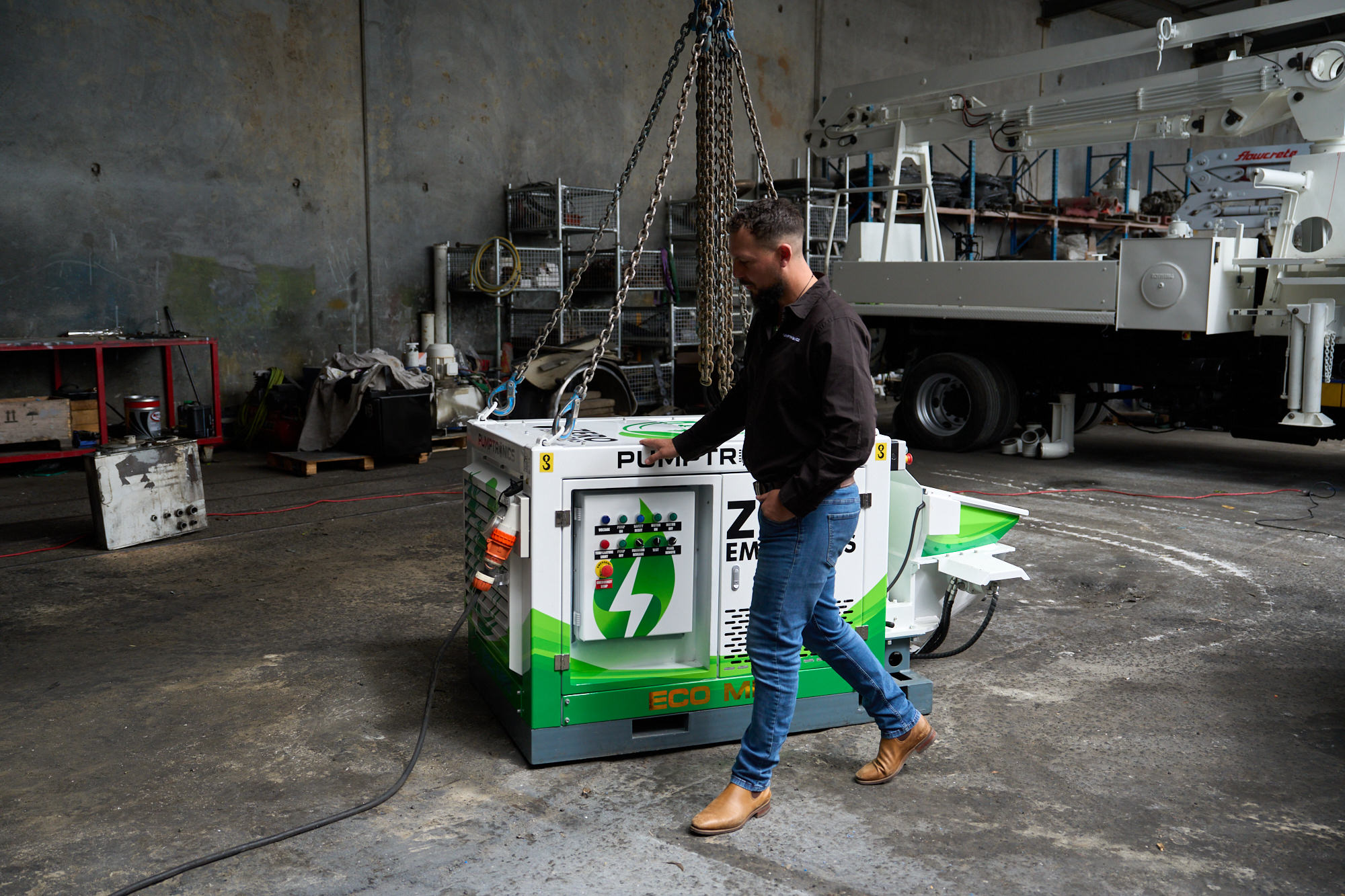 Sam walking past the Eco Mini in the workshop