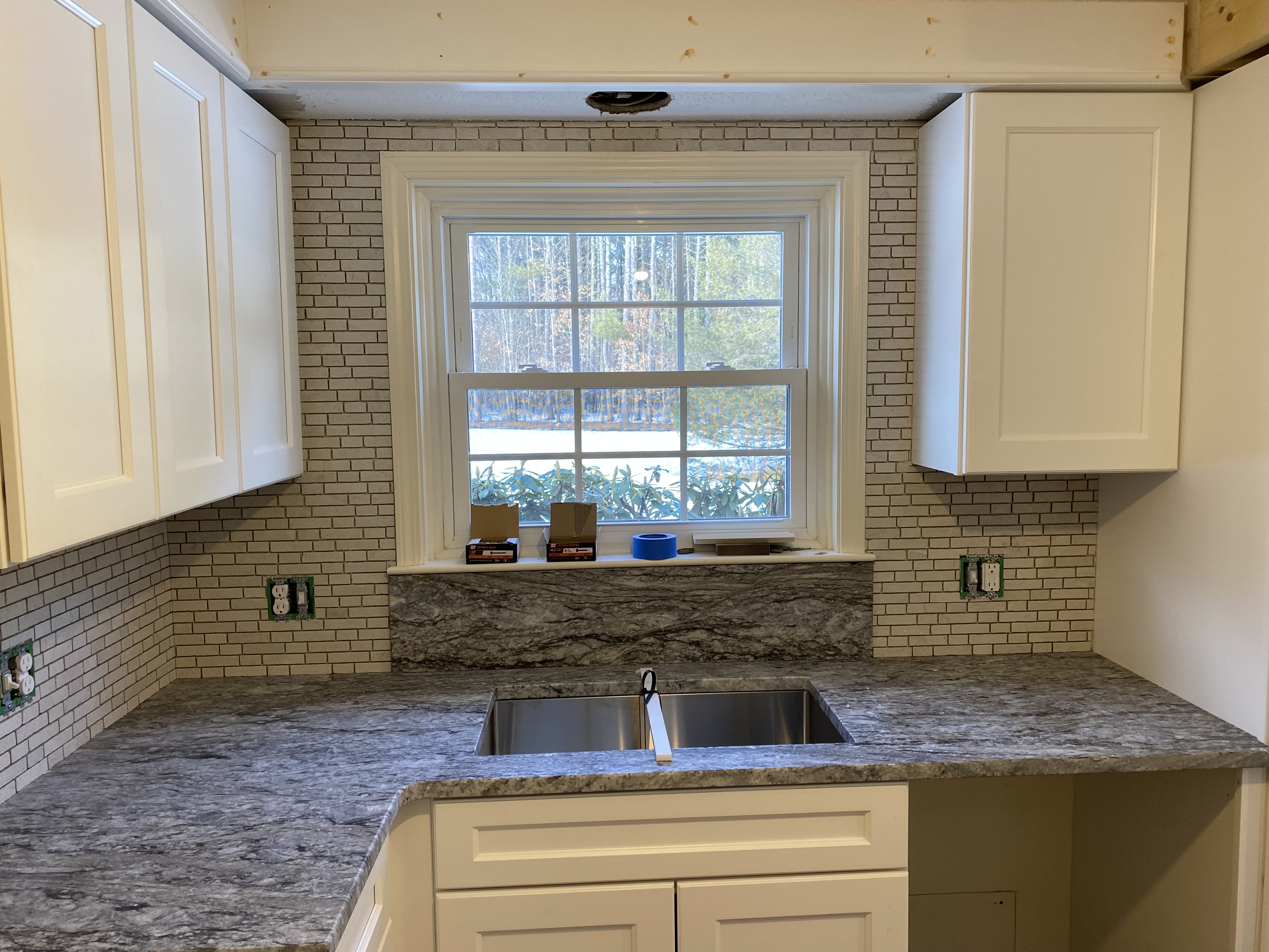 Modern kitchen with white shaker cabinets, subway tile backsplash, and quartz countertops by Cecil Design and Remodel