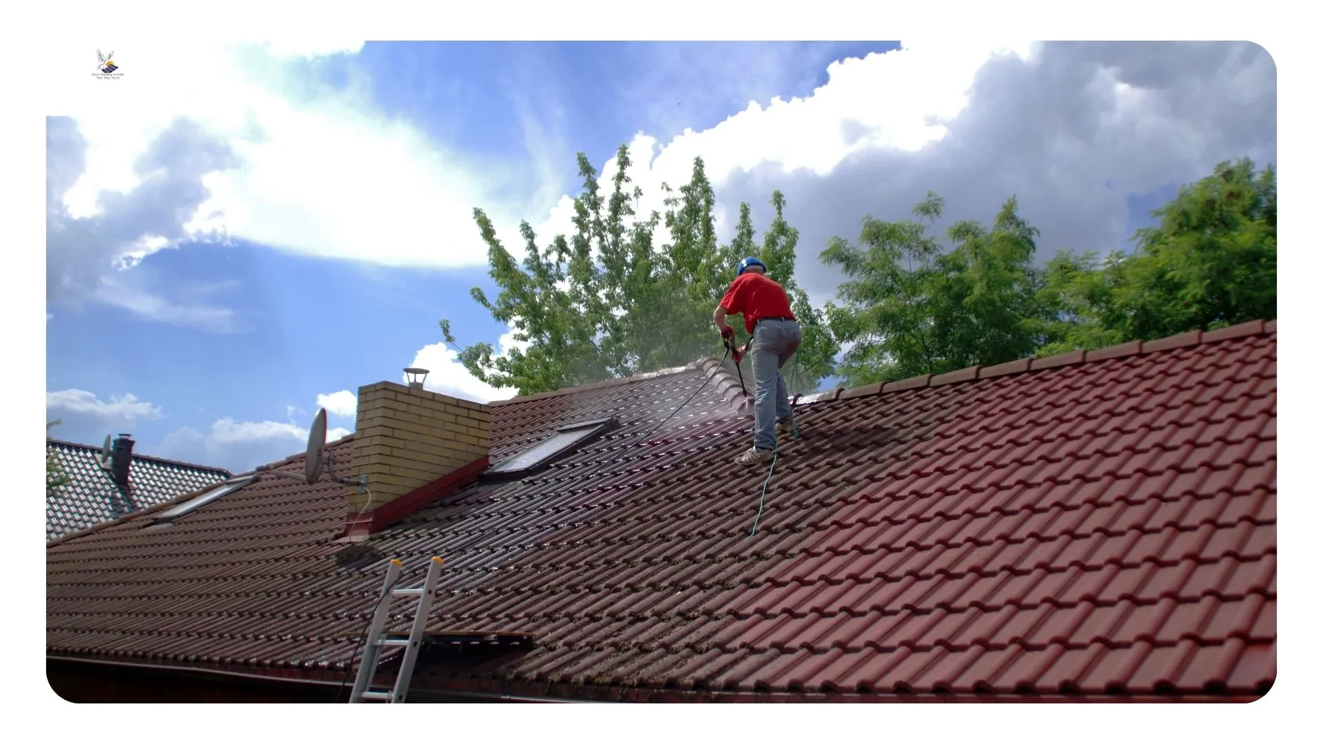 Roofer clearing packed sand and palm litter from a tile roof valley — roof cleaning Desert Hot Springs CA