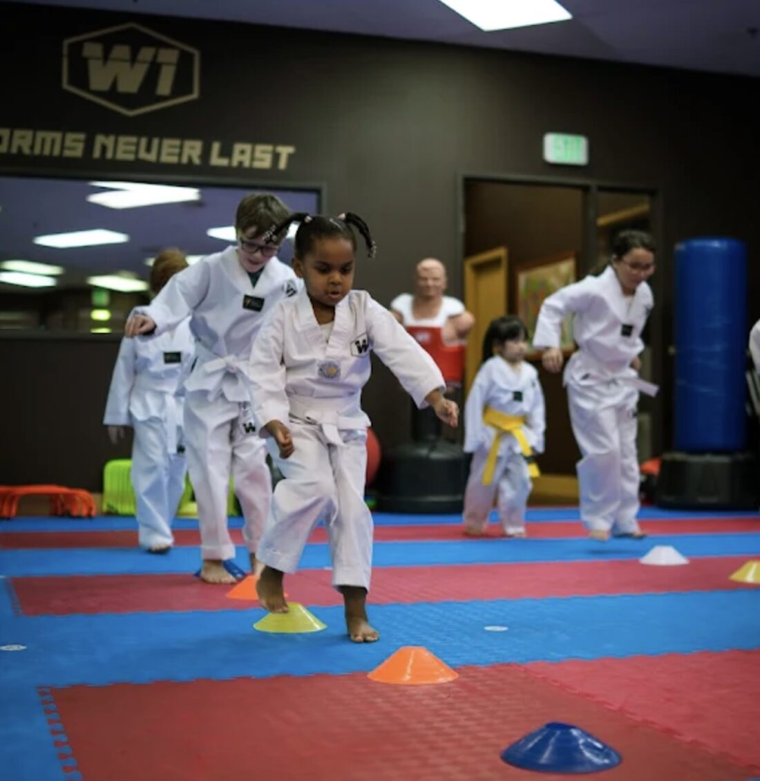 Kids running a footwork and cone drill in class at W1 Taekwondo