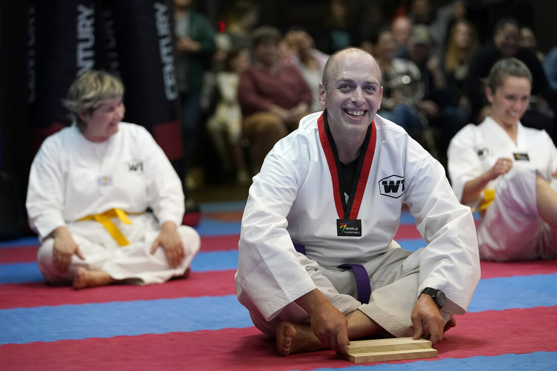 An adult student smiling, proud of a moment earned through training at W1 Taekwondo
