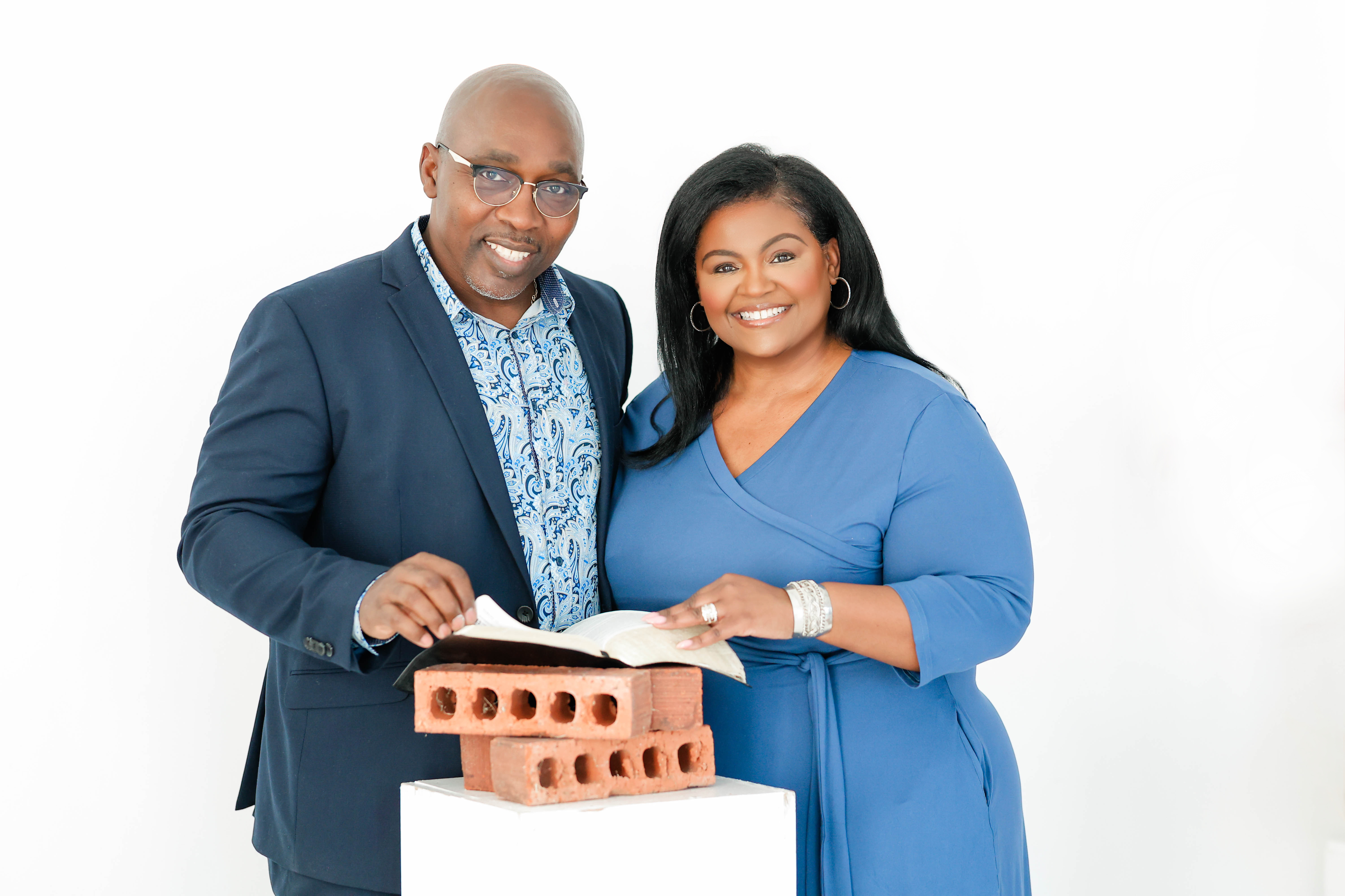 Pastors Ronald &ldquo;Jeff&rdquo; and Monti Beasley with an open Bible resting on bricks