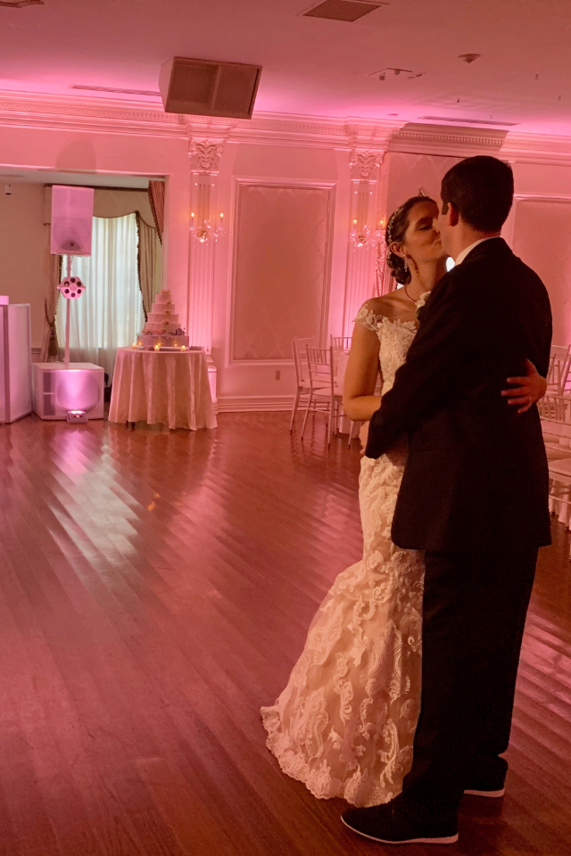 Newlyweds walking the aisle on an outdoor deck