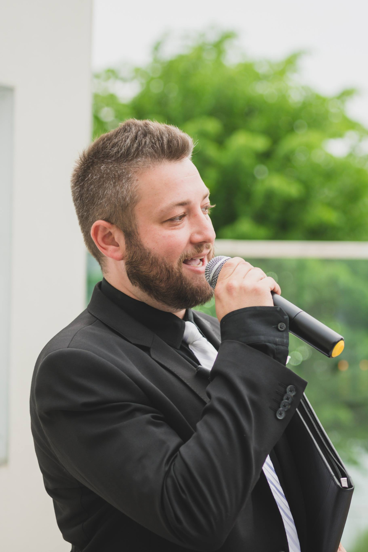 Pro DJ Productions MC speaking into a microphone at an outdoor wedding