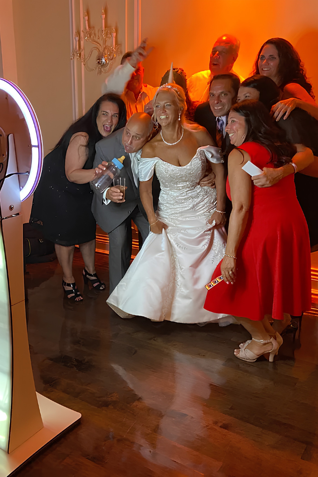 Guests on a 360 photo booth platform at an outdoor party