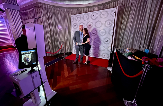 Red carpet photo booth with velvet ropes and custom backdrop
