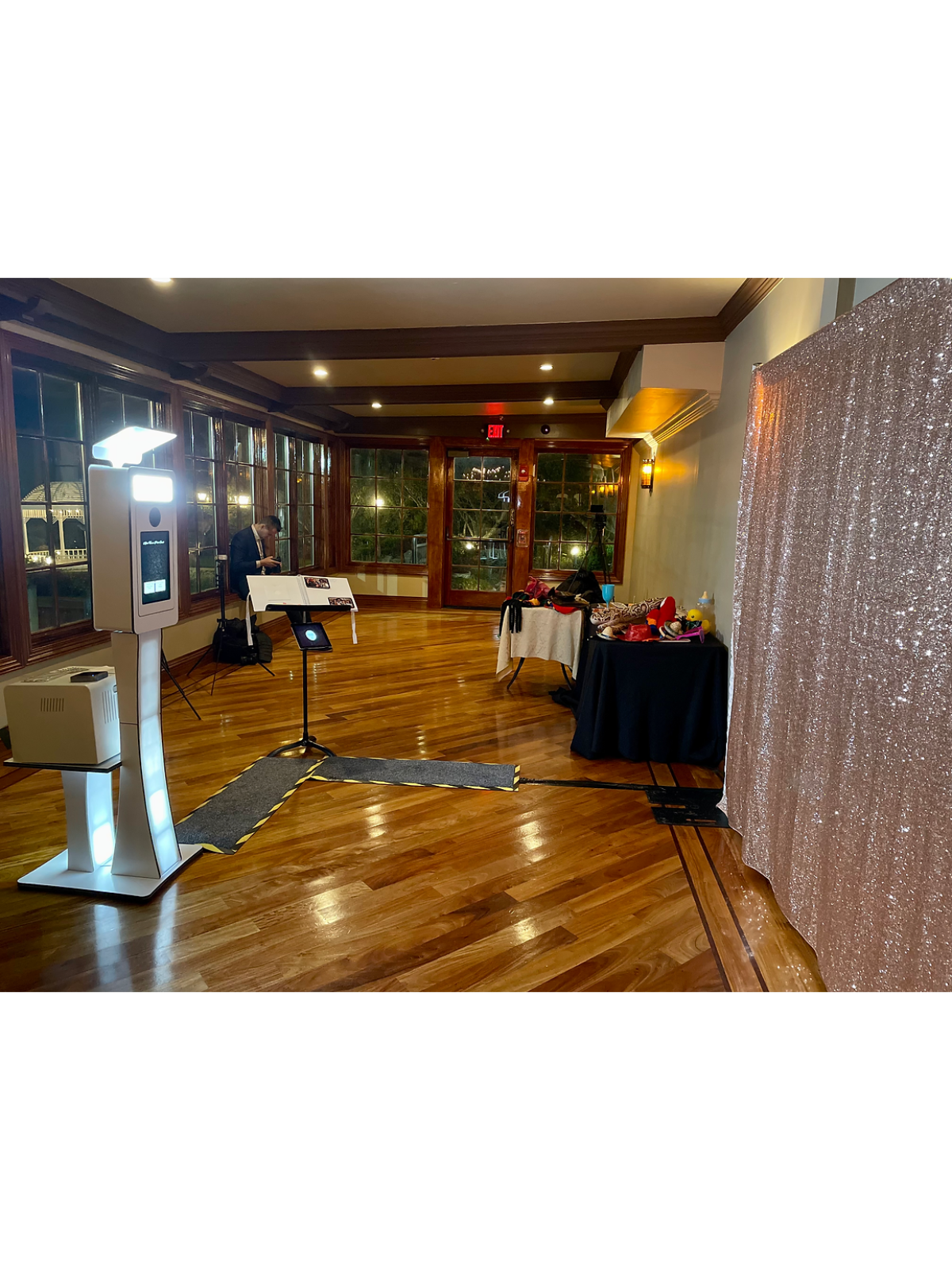 Complete photo booth area with printing station and backdrop