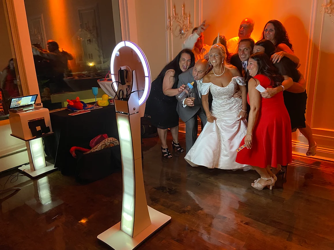 Wedding guests gathering around a photo booth