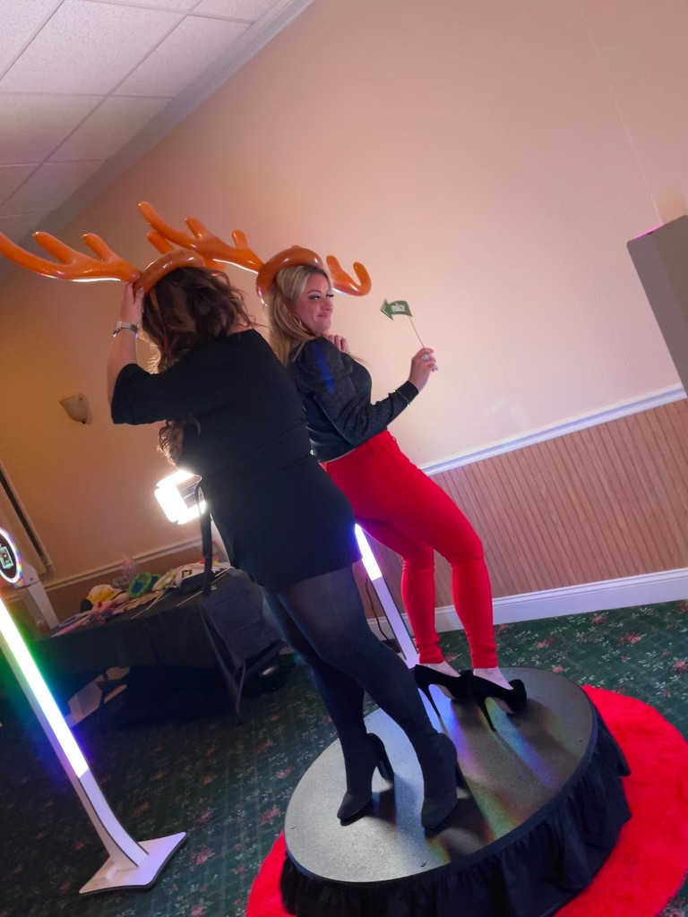Two guests dancing on a 360 video booth platform