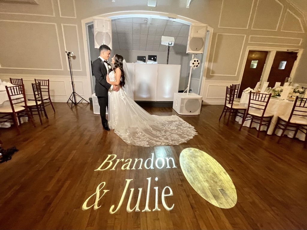 Couple's names projected in light on the dance floor