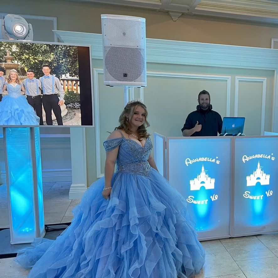 Sweet 16 guest of honor in front of a light-up DJ booth with her name