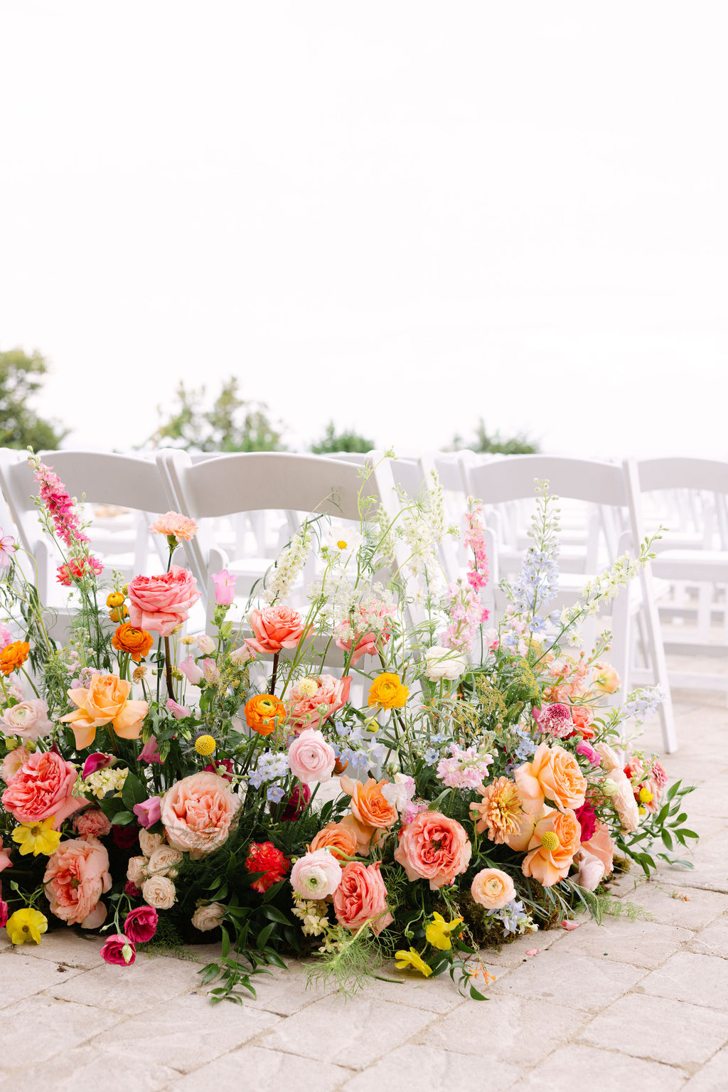 Low meadow of pastel blooms along the ceremony aisle
