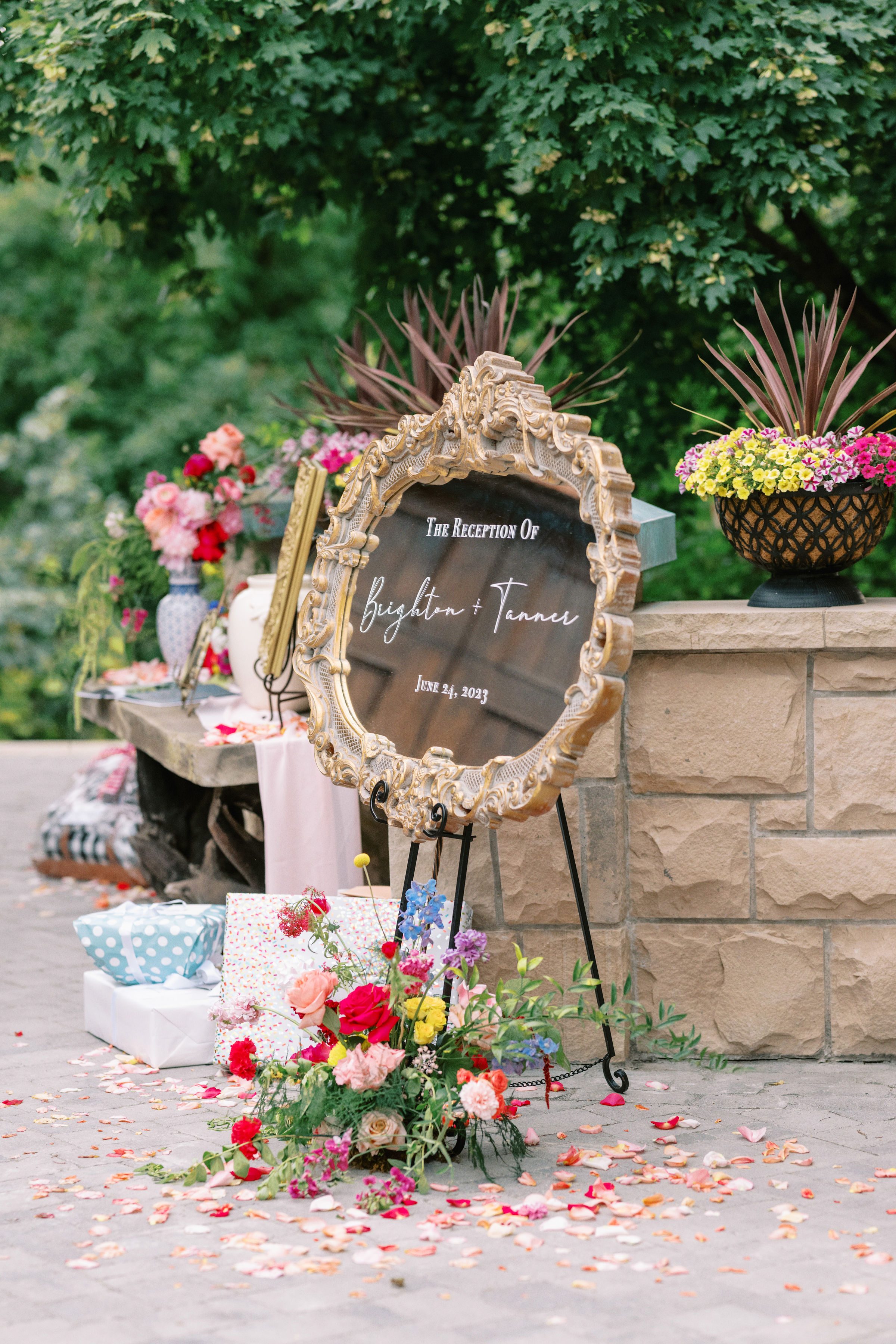 Gilded mirror welcome sign surrounded by florals