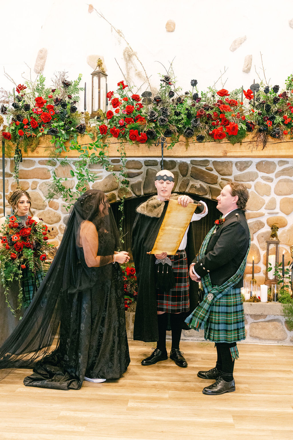Couple and kilted groomsmen before a floral-draped mantel