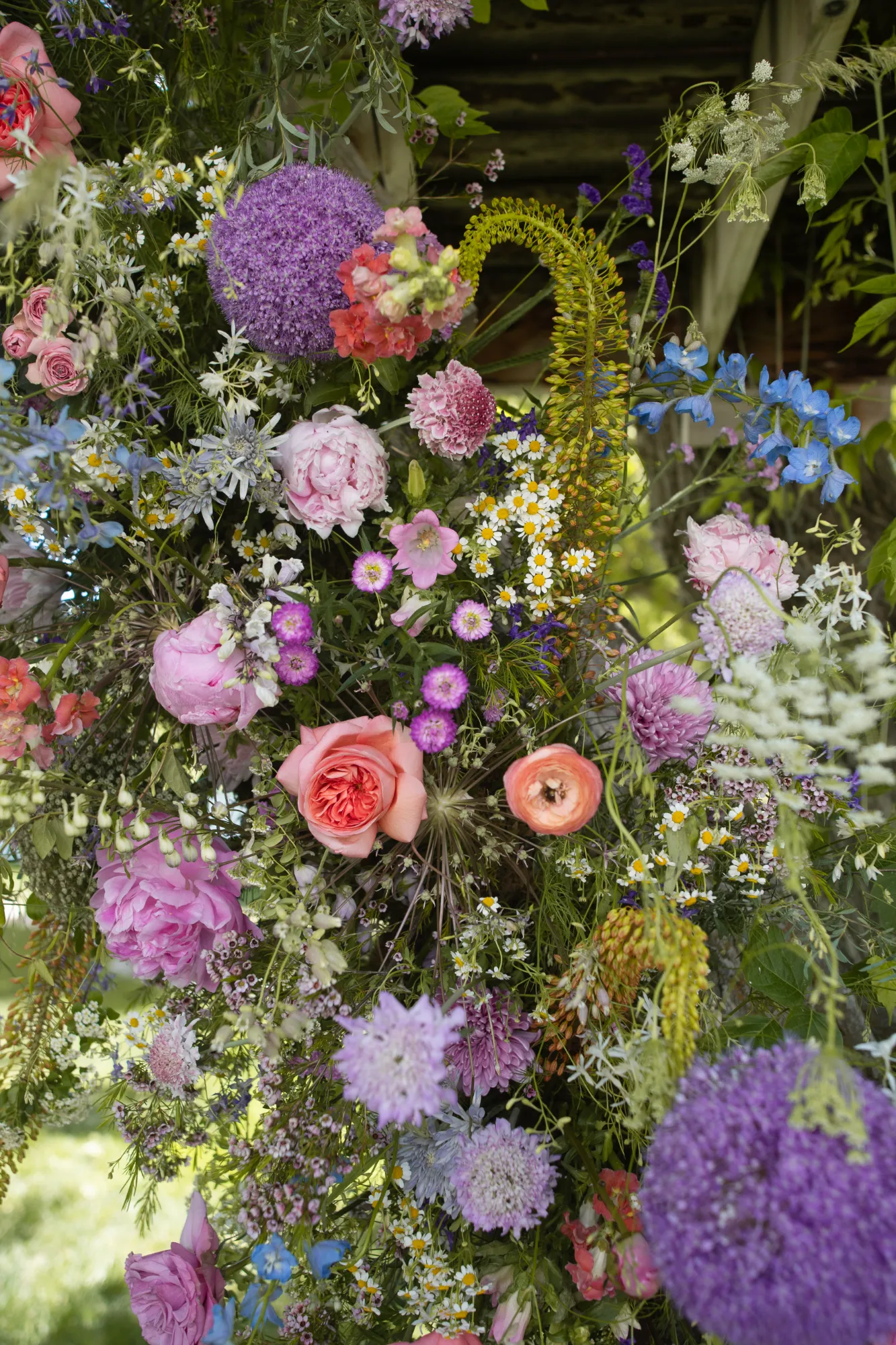 Soft arrangement of garden roses and blue delphinium