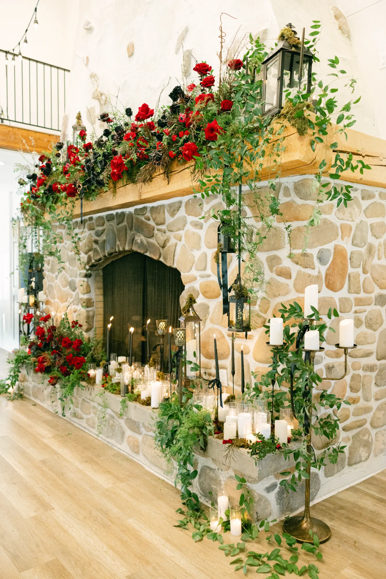 Red floral mantel installation styled for an evening event