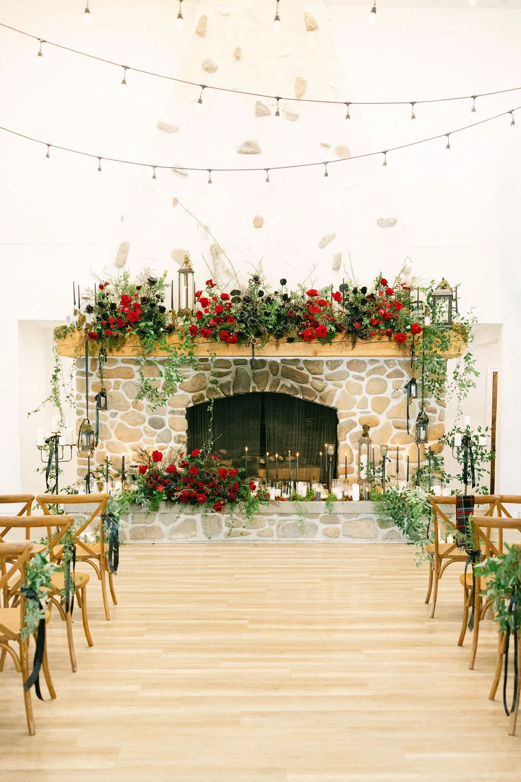 Candlelit ceremony space with floral mantel and string lights