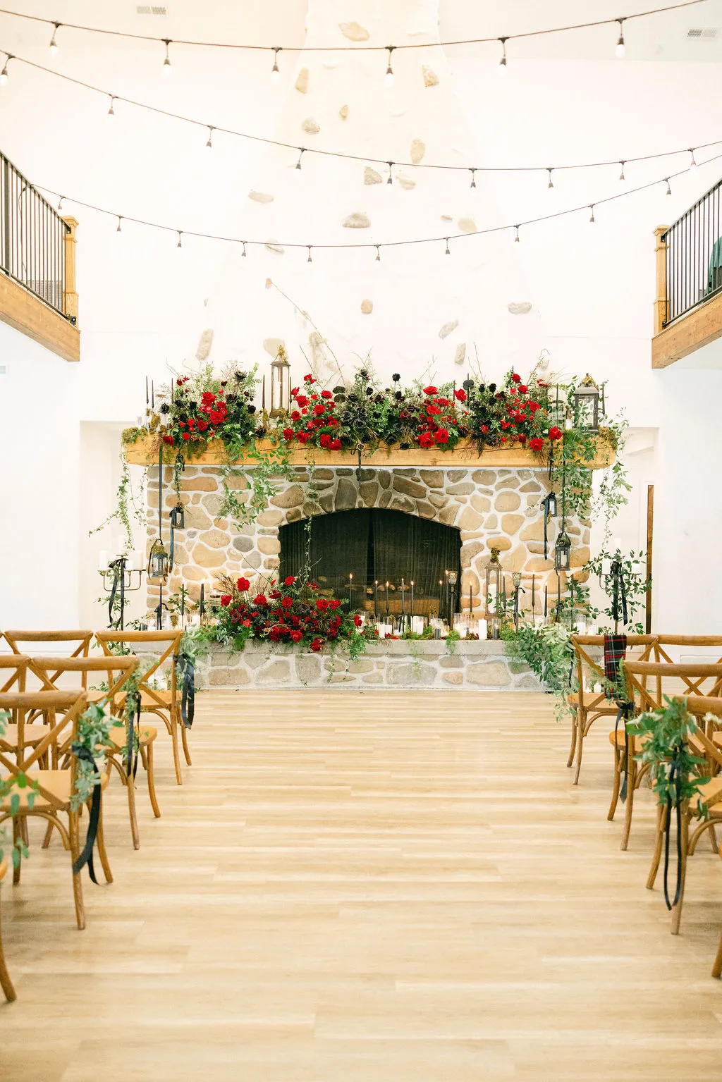 Ceremony room with fireplace florals and rows of chairs