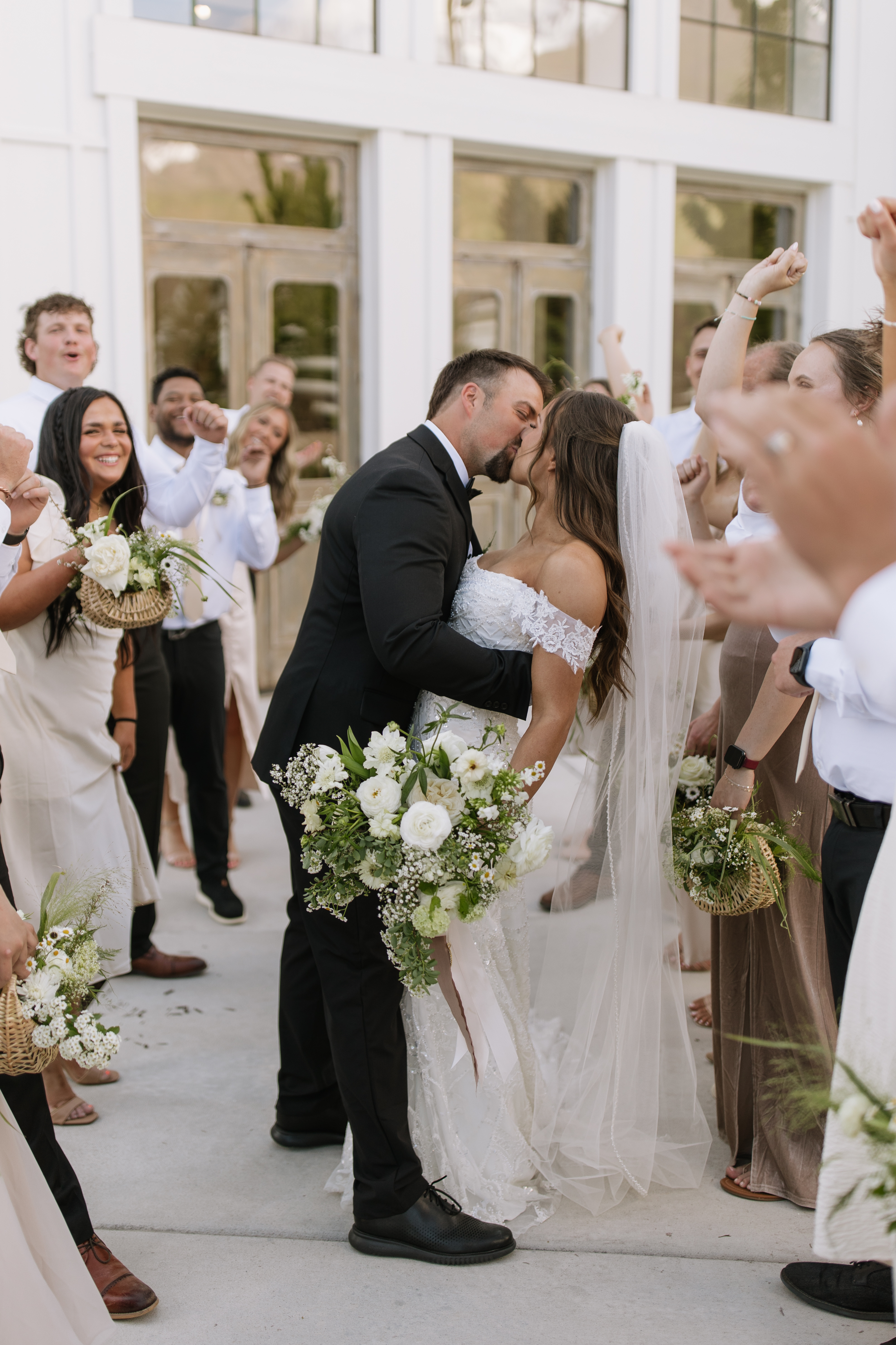 Couple celebrating as guests cheer around them