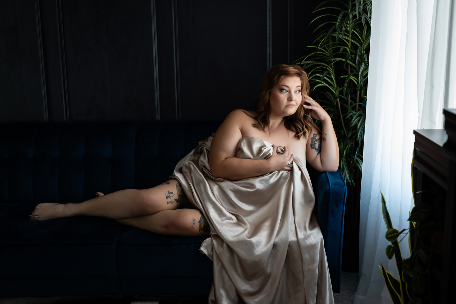 beautiful woman draped in sheets boudoir