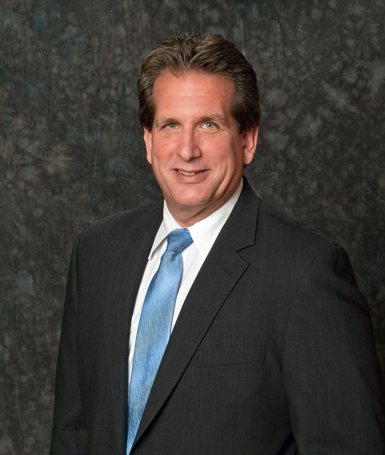 Portrait of Michael White, accredited appraiser, in a bright office.