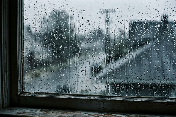 Rain on a window with grey light