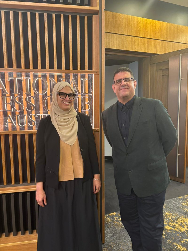 Loma Naser and Bashar Ashhab beside the National Press Club of Australia sign in Canberra