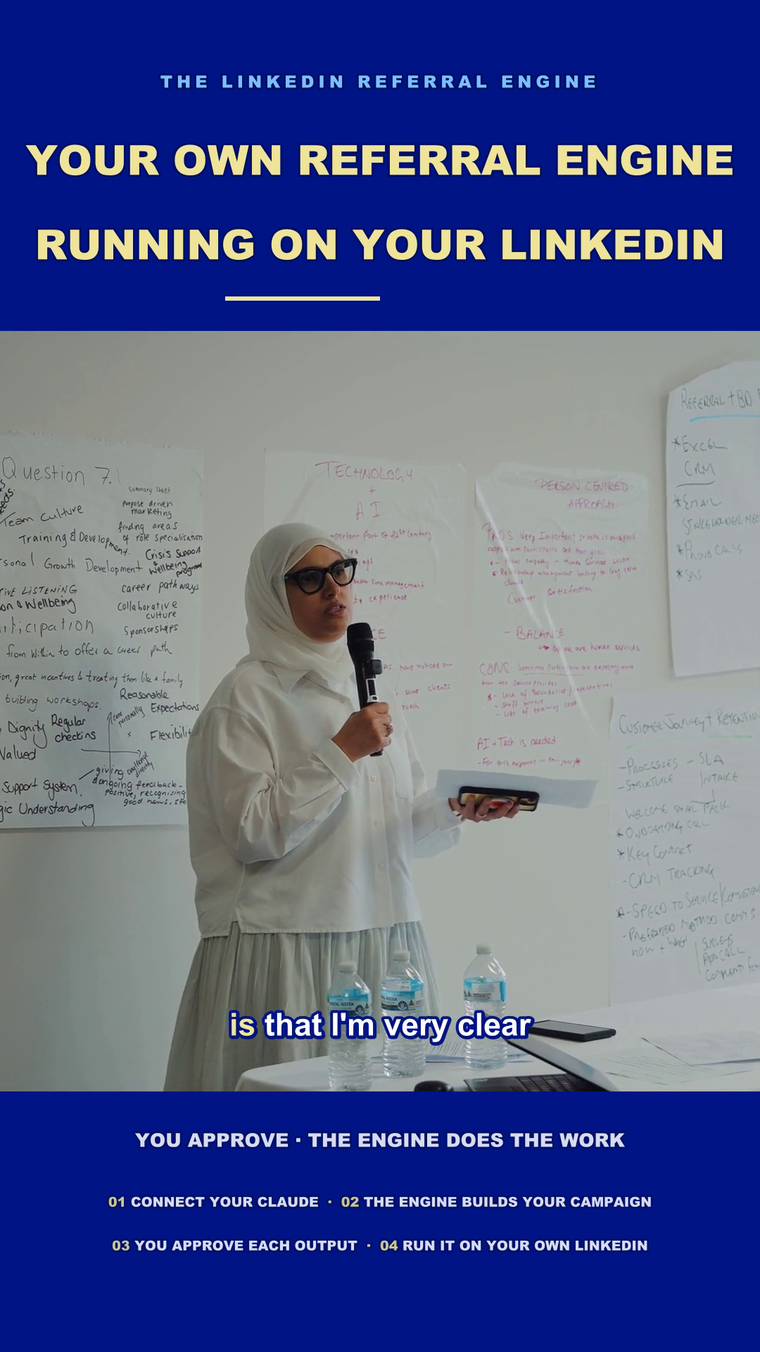Loma Naser facilitating a workshop with a microphone and written discussion notes