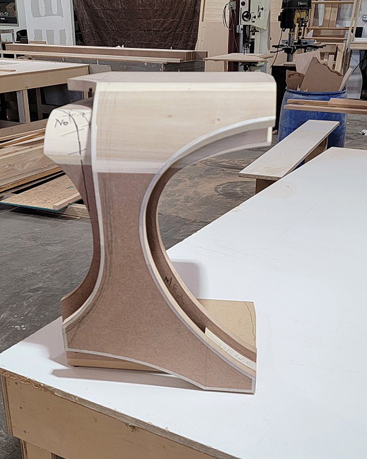Unfinished curved furniture forms in the Paul Rene workshop