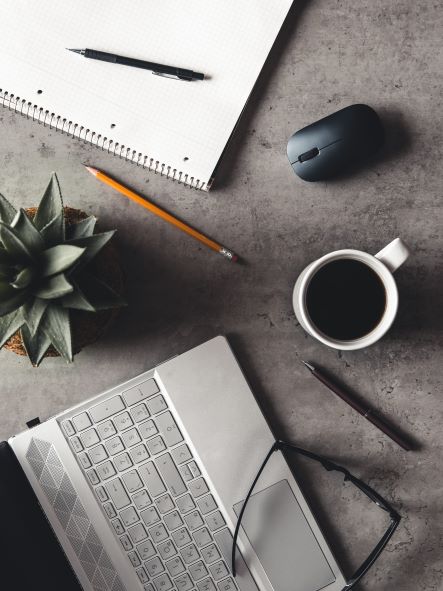 flat lay picture of desk with keyboard, coffee, and mouse