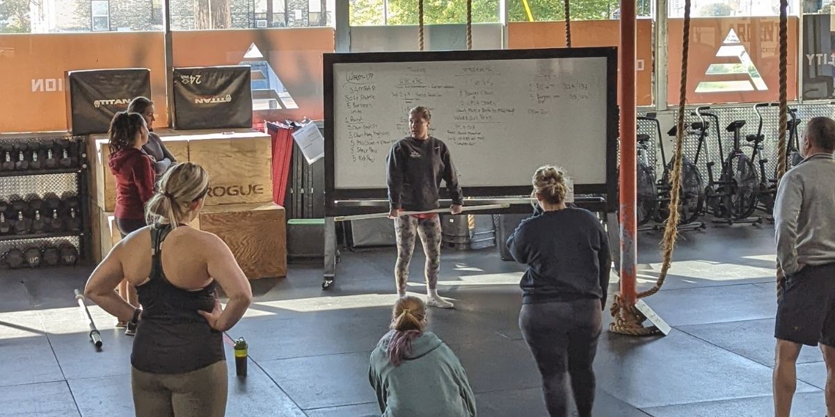 Lexi Rule coaching a members at Ardent Fitness