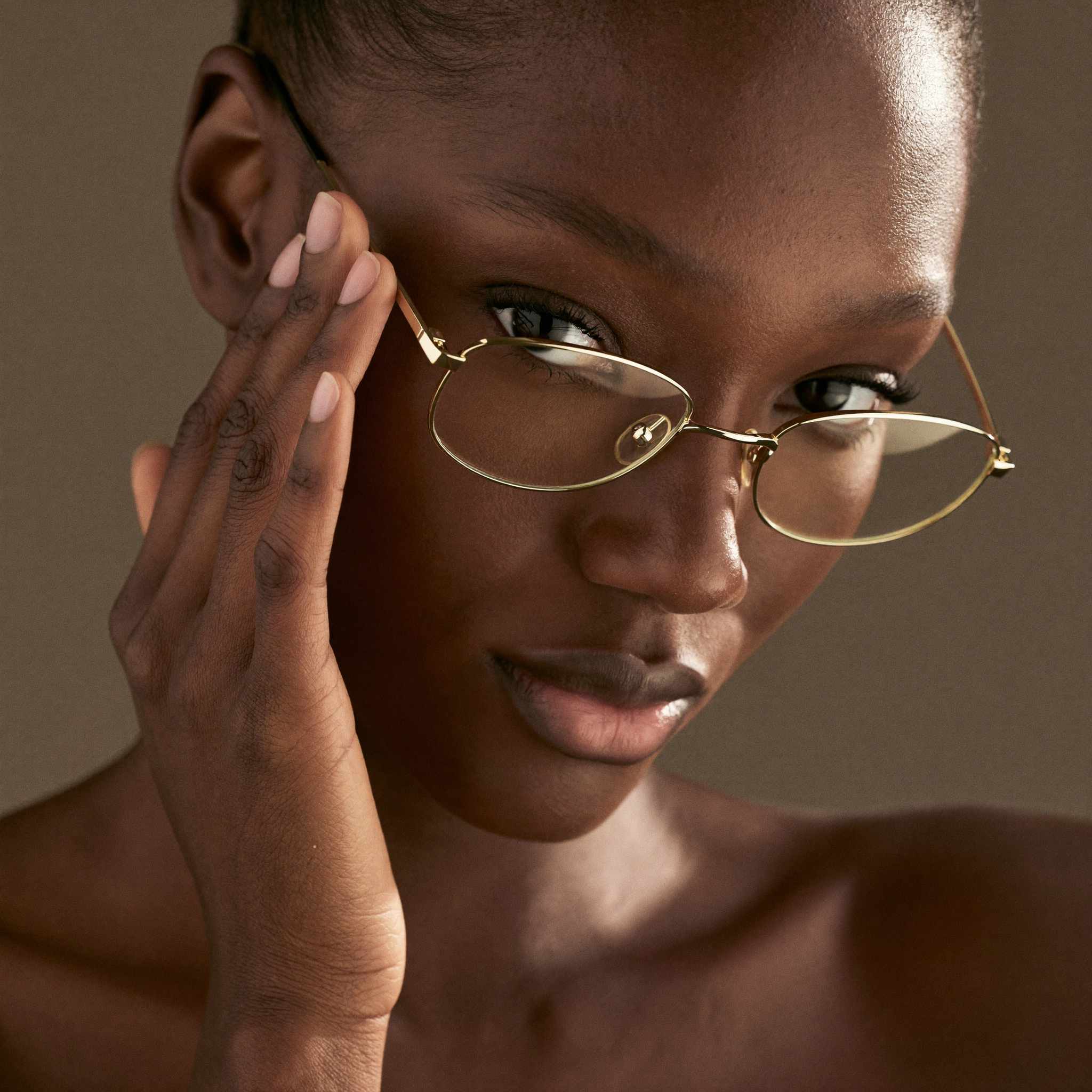 Woman wearing stylish gold eyeglass frames