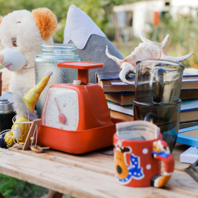 a collection of toy and dishware at a yard sale