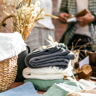 Stack of clothing items on a yard sale table