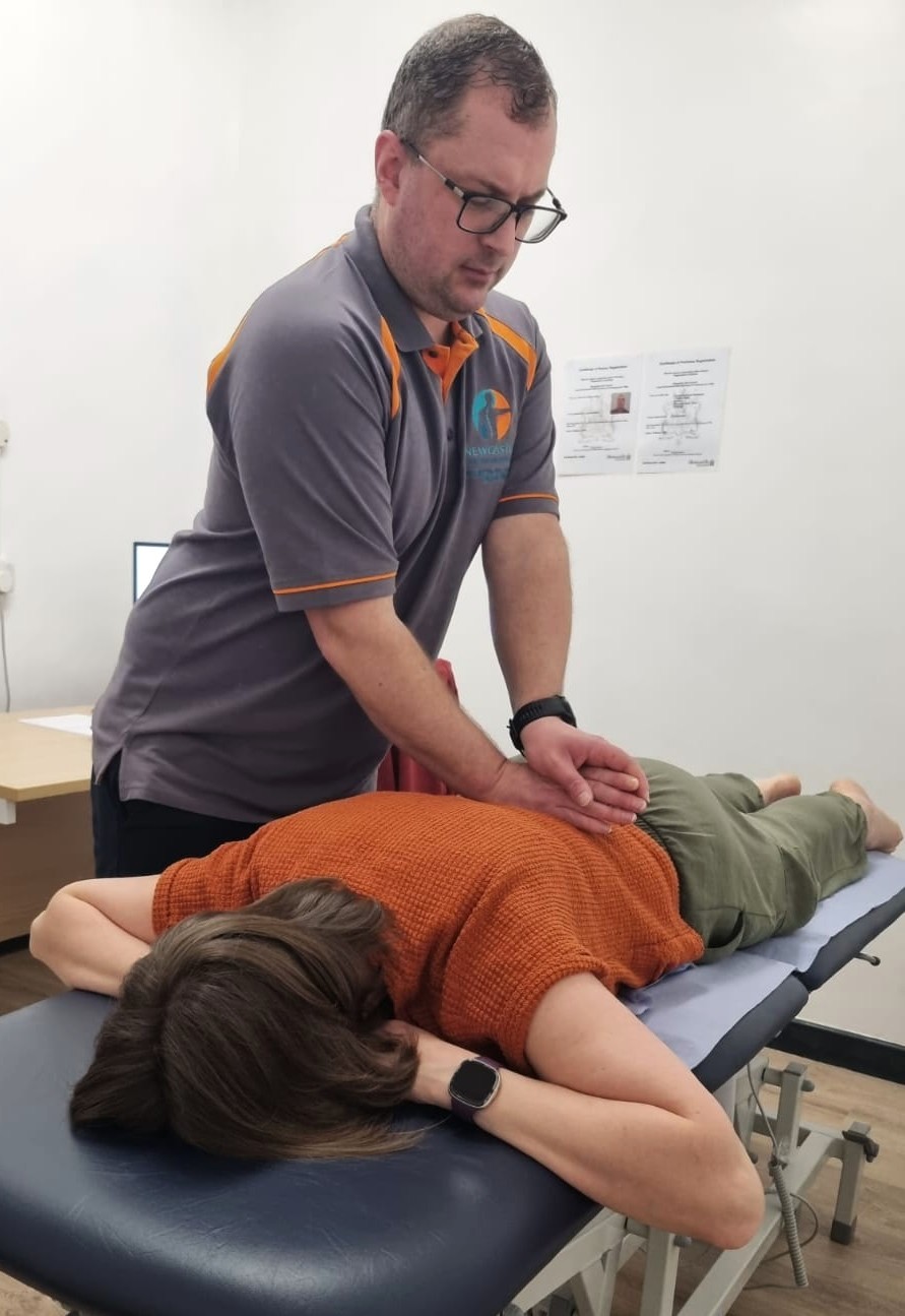 Our Physio, Ross, performing a lower back massage