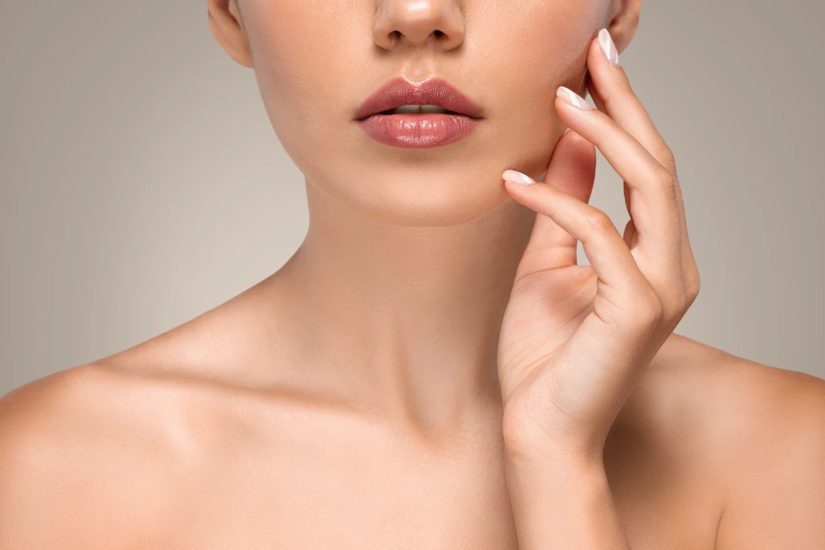Woman receiving lip filler injection from a medical professional