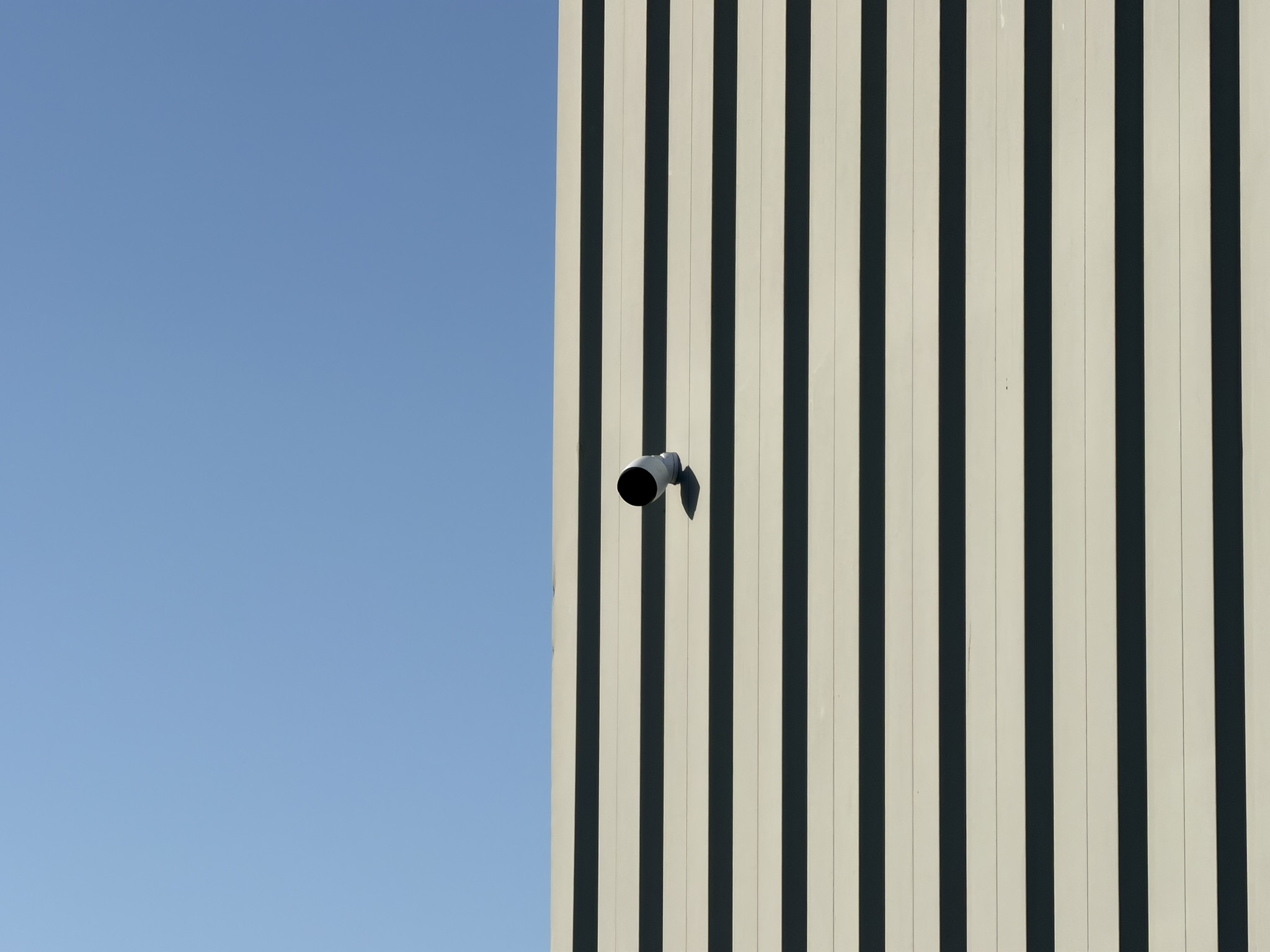 Exterior security camera with clear sightlines across parking and entry points