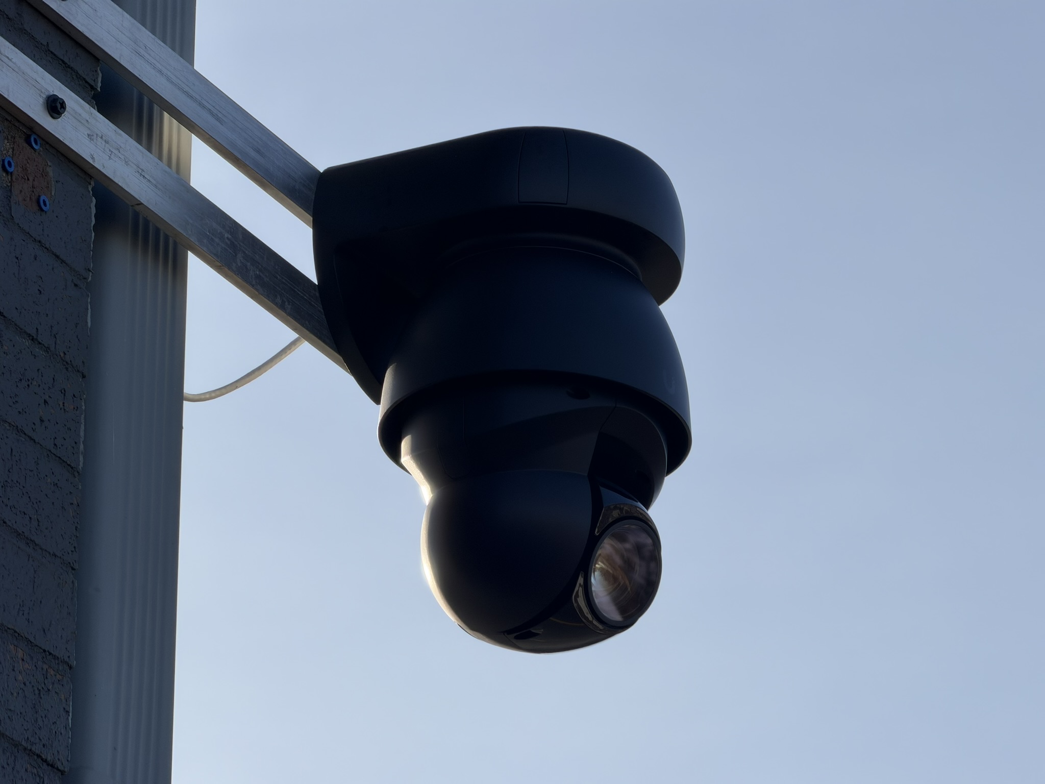 PTZ dome security camera mounted on building exterior
