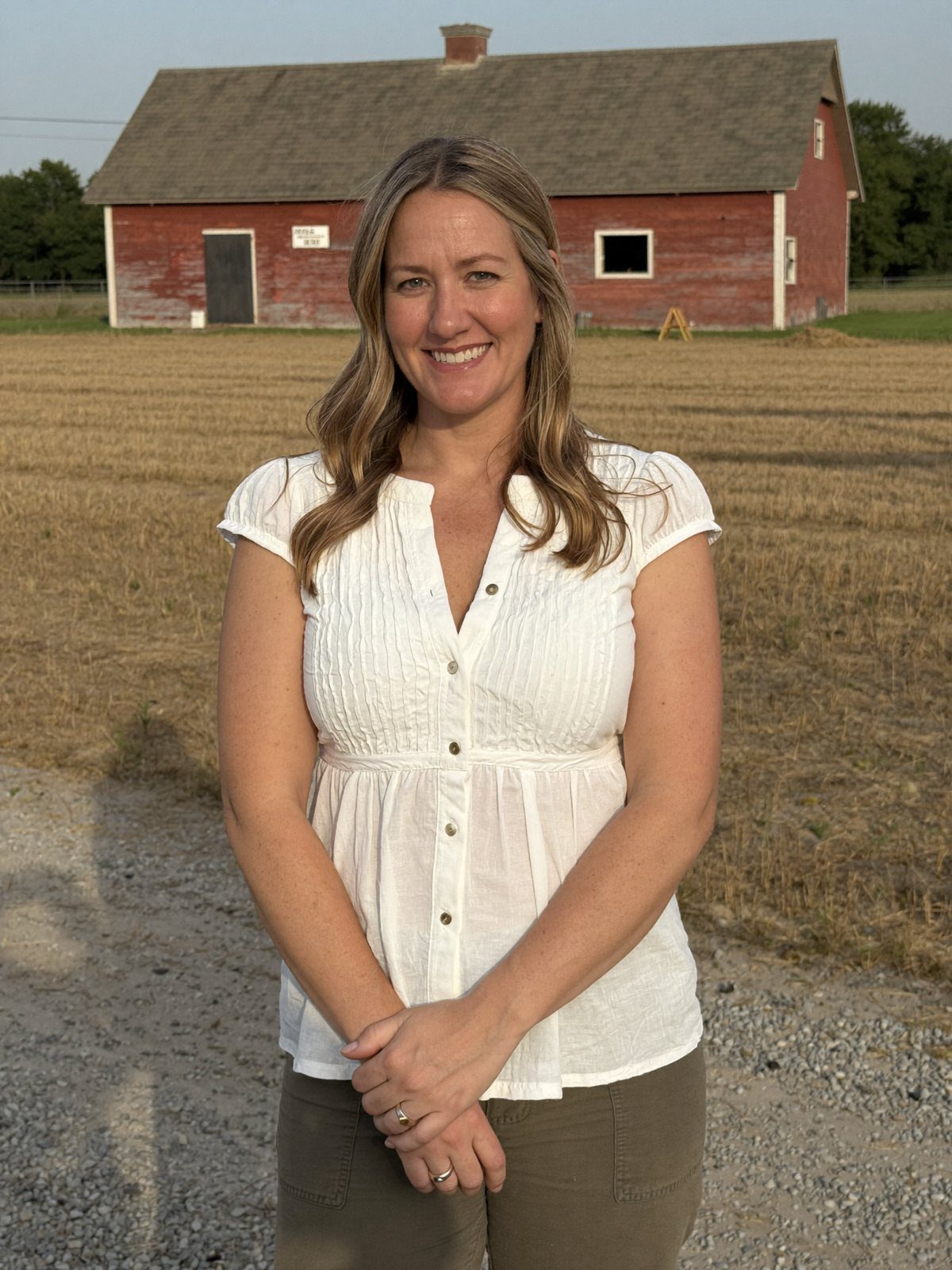 Niki Lay standing in front of a red barn