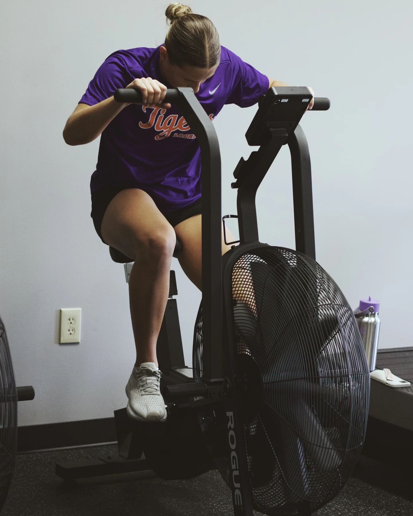 An athlete conditioning on an air bike